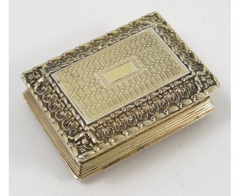 A Georgian silver gilt vinaigrette, of rectangular form, with engine turning and fancy leaf border, the grill with leaf and s