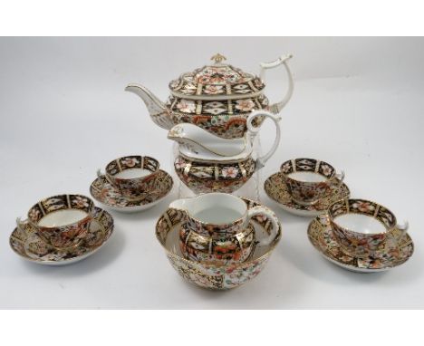 A 19th century Derby part tea service, decorated in a version of the Imari pattern, comprising teapot, two jugs, slop bowl, f