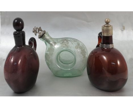 Two 19th century flask decanters, in ruby and amethyst glass, the ruby with silver plated collar and stopper, both with ring 