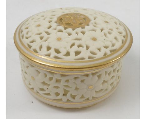 A Grainger and Co Worcester pierced ivory covered box, of circular form, decorated with flower heads, diameter 3ins