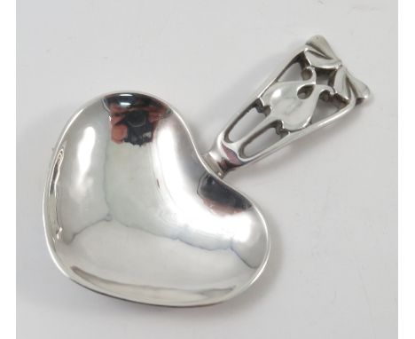 An A E Jones silver caddy spoon, the pierced handle with Art Nouveau leaf motif to a heart shaped bowl, Birmingham 1997, make