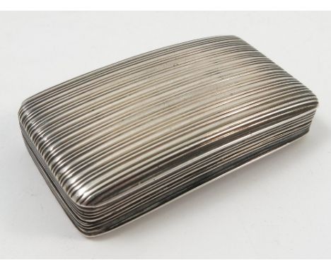 A 19th century silver snuff box, of rectangular curved form, with ribbed decoration and plaque engraved with a crest, the gil