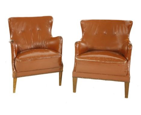 A pair of brown leather chairs, with button backs and studwork to the edges (2)