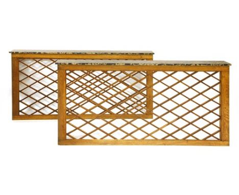 A pair of oak console tables, in the style of Jean Royère, with lattice fronts, and marble tops, 192cm wide 22cm deep 85cm hi