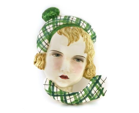 A Goldscheider wall mask, by Stephan Dakon, no. 7412, modelled as a girl wearing a tartan beret and scarf, incised and printe