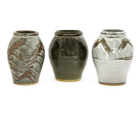 *Three John Leach Muchelney Pottery vases, each of oviod form with incised details to either the body or the shoulders, stamp