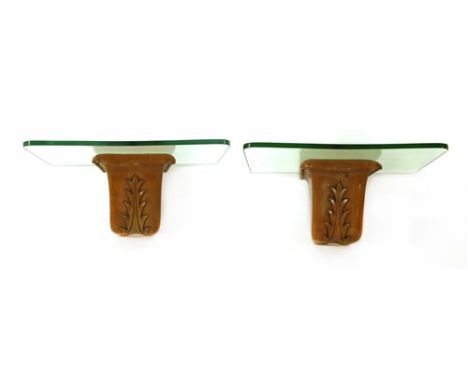 A pair of Italian maple console tables, each with glass tops, scrolled brackets and leaf details, 60cm wide 32cm deep 25cm hi