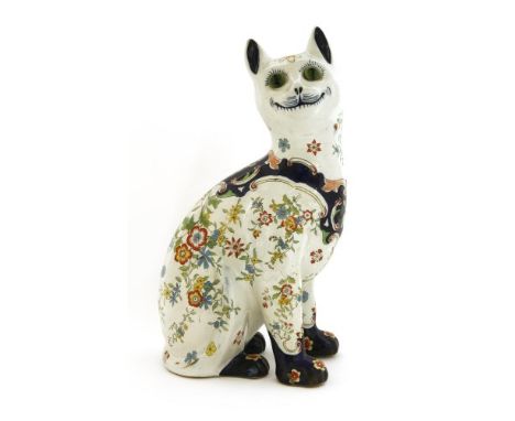 A French faience pottery cat, c.1900,in the style of Émile Gallé, an attractive painted and transfer decorated model of a sea