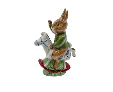 Hand modelled and hand painted figure of a Bunnykin on a rocking horse. Green coat and brown shirt. Royal Doulton backstamp. 