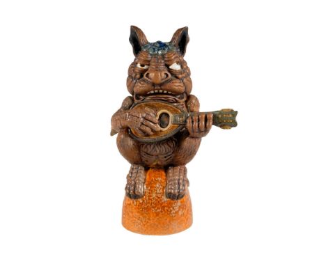 Exquisitely designed stoneware depicting a grotesque figure playing a mandolin. Limited edition 24 of 65. Highly detailed; mo