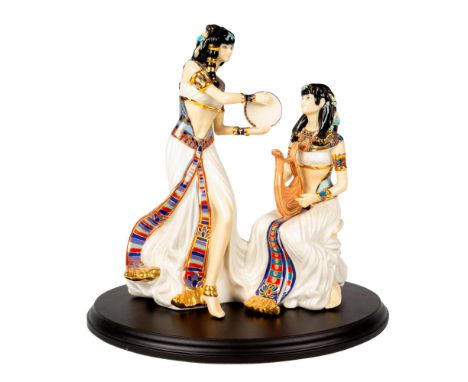 A limited edition fine china piece modeled as two Egyptian woman playing music; heavy gilt decoration. Royal Worcester backst
