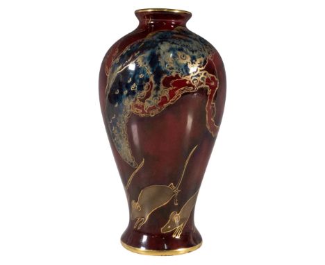 Mottled deep red glaze with a blue owl perched on a branch; white colored mice running below. Ovoid bulbous shaped with gilt 