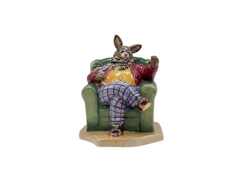 This is a special gold colorway edition of 100. Hand made and hand decorated glazed bunny sitting on an arm chair with golden