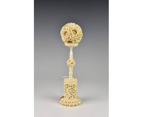 A Chinese Canton carved ivory puzzle ball on stand 1920s-30s, the 2¾in. (7cm.) ball with thirteen layers, the inner balls pie