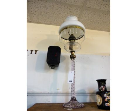 A vintage decorative glass oil lamp.