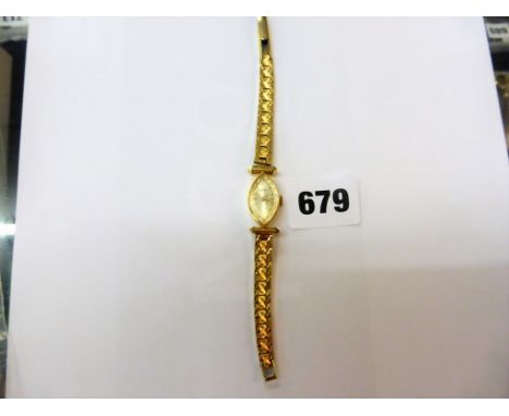 An 18ct gold cased Swiss ladies dress watch by Credos, manual wind, gold plated strap (winds and runs)