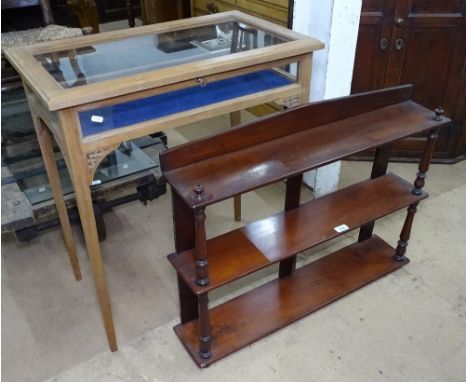 A mahogany vitrine display table on tapered legs, W70cm, H77cm, and a Victorian mahogany 3-tier hanging shelf, W81cm 