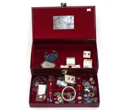 A red jewel box containing a quantity of silver costume jewellery, rings, pendants, earrings etc, and a turquoise-set bangle 