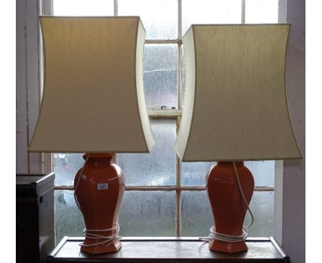 A pair of salmon ground ceramic table lamps and shades 