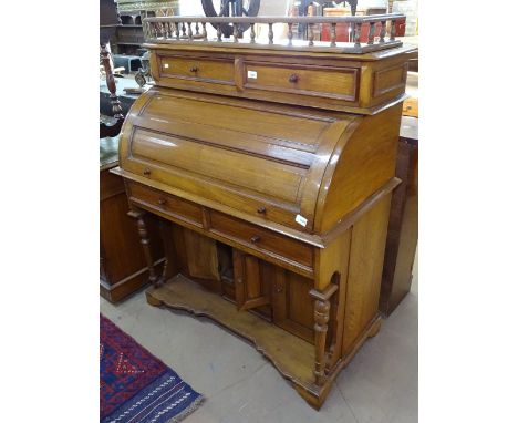 A modern hardwood cylinder-front roll-top desk, with fitted sliding interior, cupboards and drawers under, on bracket feet, W