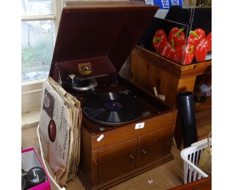 An HMV mahogany-cased wind-up gramophone, with speaker cupboard and selection of records, case length 45cm 