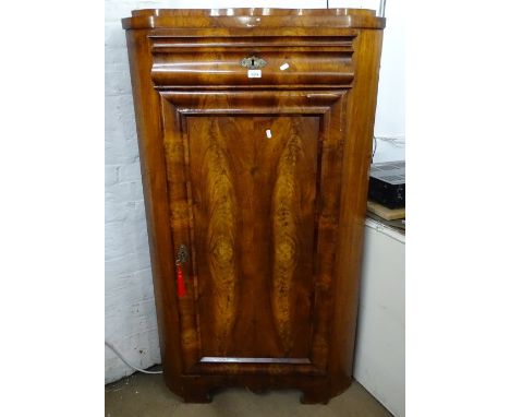 A 19th century walnut corner cupboard, with ogee frieze drawer above a panelled cupboard door, on bracket feet, W83cm, H147cm