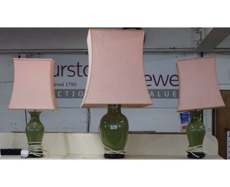A pair of Oriental design celadon baluster table lamps and shades, and a similar celadon table lamp and shade 