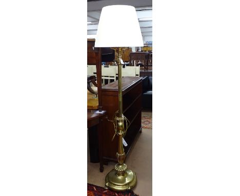 A Victorian brass floor standing oil lamp converted to electric with shade 