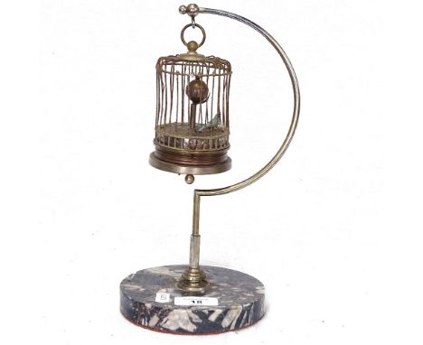 A reproduction bird in cage clockwork automaton, on marble base, height 28cm 