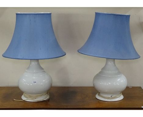 A pair of white ceramic baluster table lamps and blue shades, overall height 72cm 