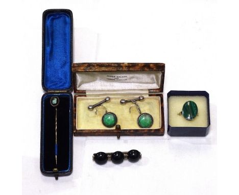 A box containing an opal stick pin, a pair of silver and jade cufflinks, an onyx and silver brooch and matching ring 