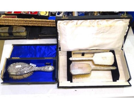 An Art Nouveau silver-backed dressing table brush, boxed, and a silver engine turned dressing table brush set, boxed (2) 