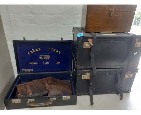 A vintage black salesman travelling case for the iconic French wellness apothecary Creme Simon products having a blue lining 
