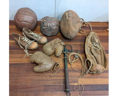 Vintage sporting equipment to include two leather footballs, a rugby ball, a pair of boxing gloves, football boots and others