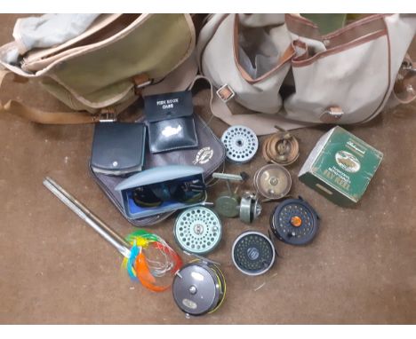 Fishing equipment to include 2 gilets, 2 tackle bags with contents and fishing reels to include a vintage 'The Fly Fishers SE