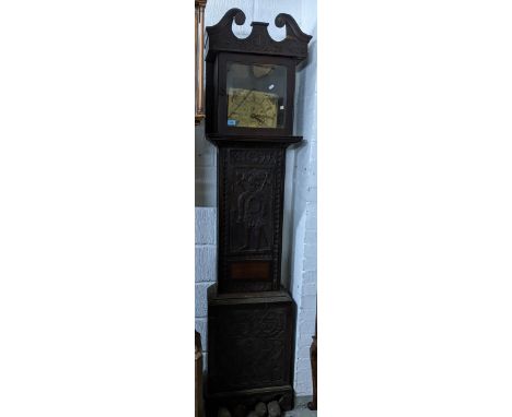 A Georgian carved oak cased longcase clock, with matched brass face clock movement, the engraved face with Roman numerals and