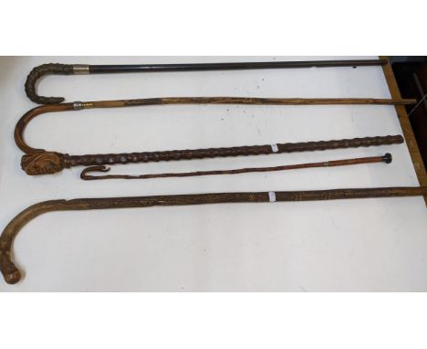 A collection of vintage walking sticks to include a carved and turned example , in an Oriental style pattern with mother of p