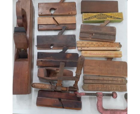 A quantity of vintage tools to include wooden planes, rules and G-clamps and an English beechwood plane. Location:A2M 