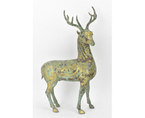 A Chinese patinated bronzed model of a stag, decorated with gilt scroll designs and character marks, 39cm high x 20cm wide LO