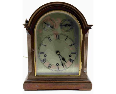 AN EDWARDIAN MAHOGANY CASED MANTEL CLOCK, of Georgian design, having arched silvered dial with Roman numerals and secondary s