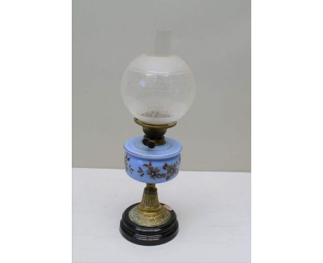 A VICTORIAN OIL LAMP with blue floral decorated reservoir on brass base with etched glass shade and chimney, overall height, 
