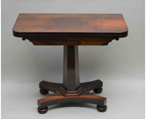 A WILLIAM IV ROSEWOOD FOLDOVER SWIVEL TOP CARD TABLE on tapering faceted column supported on plinth base with recessed bun fe