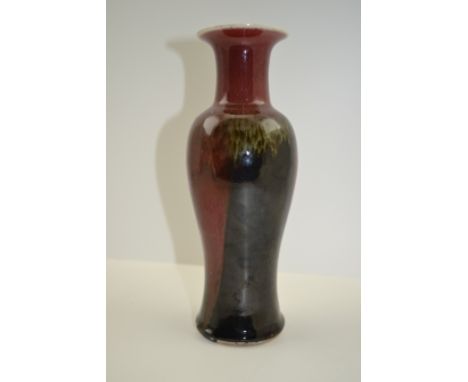 A CHINESE CERAMIC VASE of baluster form, in a mottled part sang de boeuf glaze, 22cm high 