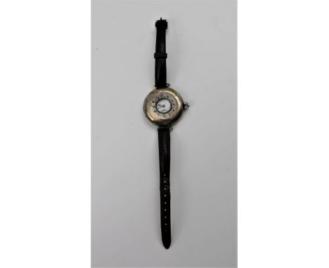 AN EARLY 20TH CENTURY SILVER CASED HALF HUNTER STRAP WATCH, the cover with blue Arabic numerals about a lenticel, opens to re