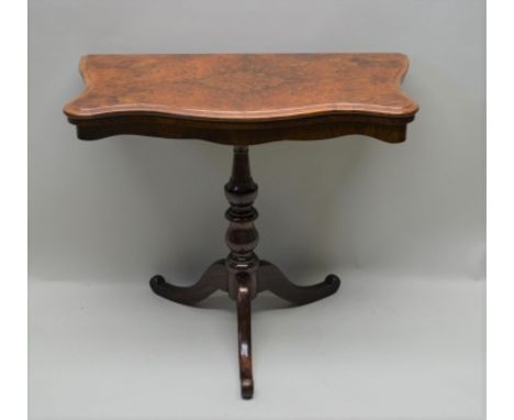 A 19TH CENTURY POLLARD WALNUT TOPPED FOLDOVER CARD TABLE having serpentine shaped front, supported on an associated turned si
