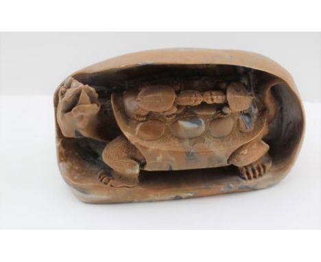 A CHINESE CARVED SOAPSTONE TURTLE inside a boulder, with two babies on it's back, 18cm wide 