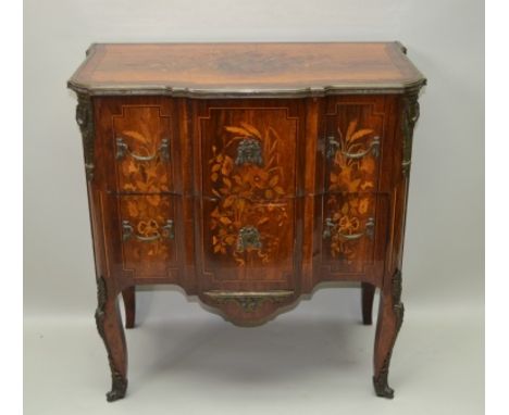 A PROBABLE 18TH CENTURY DUTCH COMMODE having profuse floral marquetry inlay, with decorative cast brass mounts, having fancy 