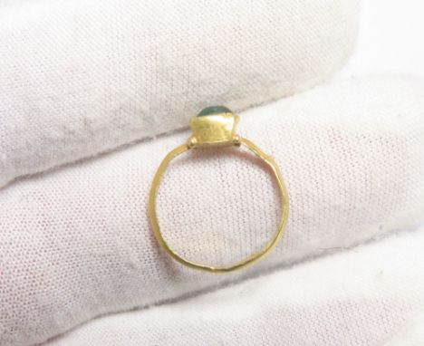 Roman gold ring with green glass cabochon. Circa 3rd-4th century CE. A fine D-sectioned band with a rectagular box type bezel