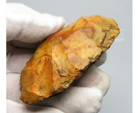 Neolithic flaked flint axehead c. 4000BC - 3000BC. A nicely knapped piece fabricated from grey flint, now having a deep orang