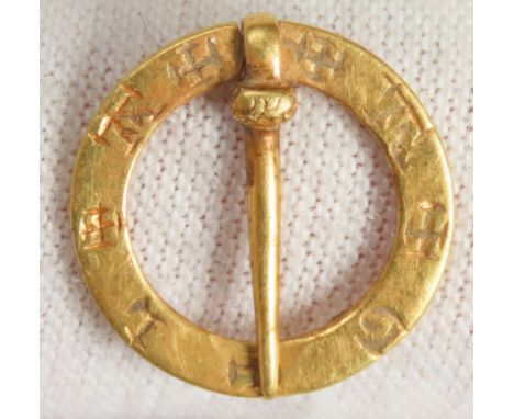 Medieval Gold Annular Brooch. Circa 1200-1350 CE. 14mm, 1.32g. The face of the brooch is decorated with an incised inscriptio